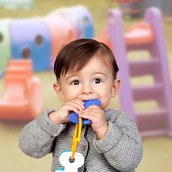 Child exhibiting hand-to-mouth behavior 