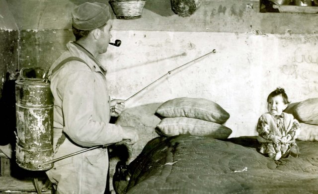 American GI spraying DDT in Italian home